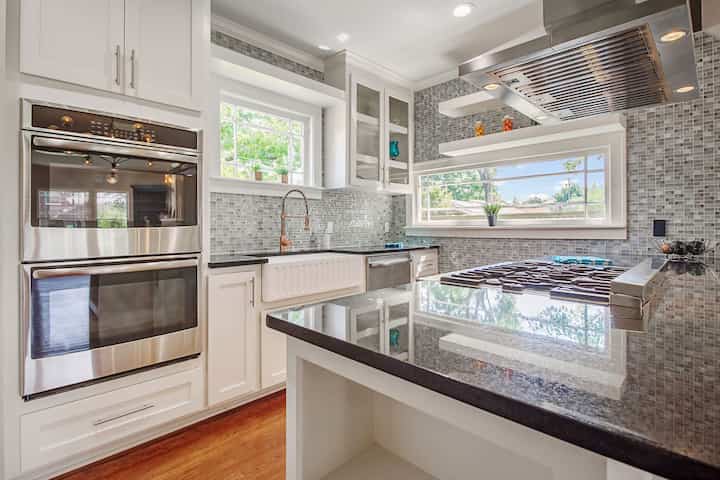 An image of a modern kitchen with sleek appliances, featuring a gas stove, refrigerator, and built-in microwave in Redding